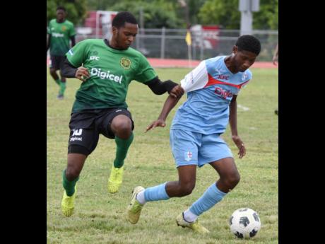 Tae-Sean Oneil (right) of St.George’s College wins the ball from Rushike Kelson of Calabar High during their Manning Cup football match at Ashenheim Stadium, Jamaica College last season. Calabar won the match 7-1.