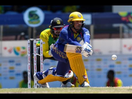 Quinton de Kock (right) of Barbados Royals hits a four as Amir Jangoo of Jamaica Tallawahs watch, during their Caribbean Premier League (CPL) match at Daren Sammy National Cricket Stadium yesterday in Gros Islet, St Lucia.