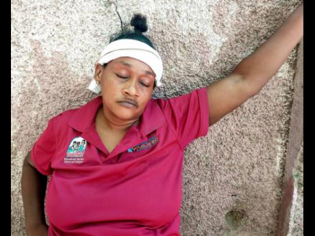 Credit: Roxroy McLean A dejected Ayoka Clarke, whose son, RicardoTyrell, was killed in Craig Town, St Andrew, on Tuesday night.