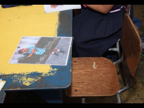 A photo of six-year-old Jevanie Kidd rests at the desk he once occupied at Catadupa Primary and Infant School in St James.