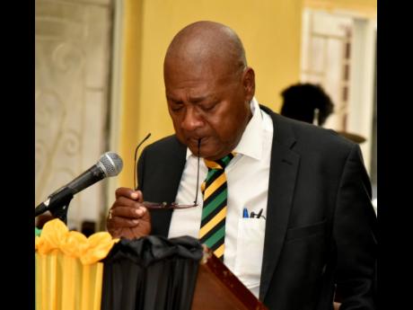 An heartbroken Michael Ricketts, president of the Jamaica Football Federation, delivers a tribute at the funeral for young reggae girl,  Jedine Carr, in Heartease, St Thomas on Saturday.