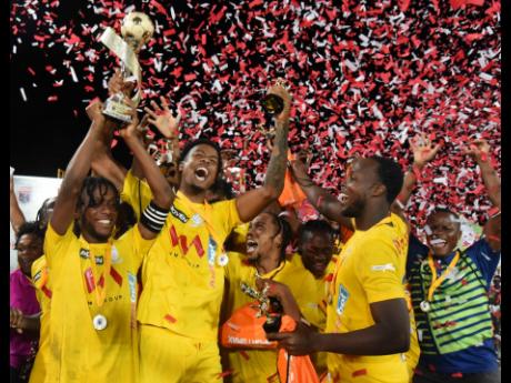 Members of Harbour View FC celebrate after being presented with the Jamaica Premier League (JPL) trophy at Sabina Park in July. They defeated Dunbeholden in the final.