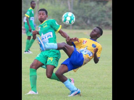 Old Harbour High’s Kirkland Smith (left) and Tacius Golding High’s Owen Simms battle for possession during their ISSA/Digicel daCosta Cup Group M encounter at Port Esquivel last Tuesday. Old Harbour won 3-1.