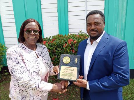  Dorrset Taylor, acting principal of Frome Technical High School (left),  presents a plaque to Neville Saddler, after the past student donated $500,000 to the school this week.