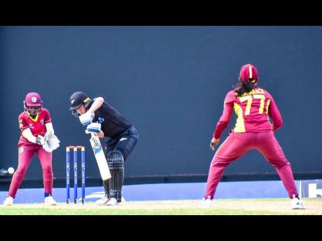 New Zealand’s Maddy Green (centre) plays to the offside during her player-of-the-match performance, while being watched by West Indies’ wicketkeeper Rashada Williams (left) and bowler Karishma Ramharack during their second one-day international (ODI) at the Sir Vivian Richards Stadium in Antigua yesterday. New Zealand won the match to win the series.