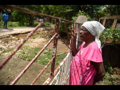 Credit: Nicholas Nunes/Photographer A marooned Hyacinth Rowe, a resident on Green Bottom, Clarendon, looks out from her yard.