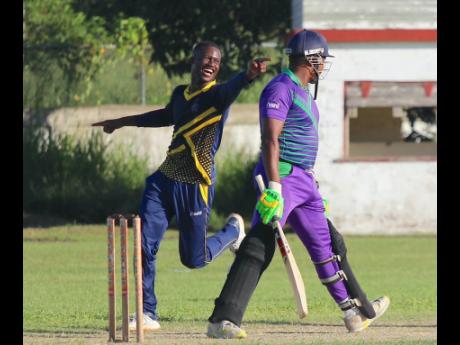 Jamaica Defence Force spinner Kevin Daley celebrates after claiming the wicket of Kensington’s batsman Jamie Hay during their JCA T20 Bashment quarter-final encounter at Chedwin Park, yesterday.