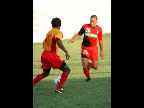 Kevin ‘Pele’ Wilson (right) in action for Arnett Gardens FC during a National Premier League match against Village United in 2005.   