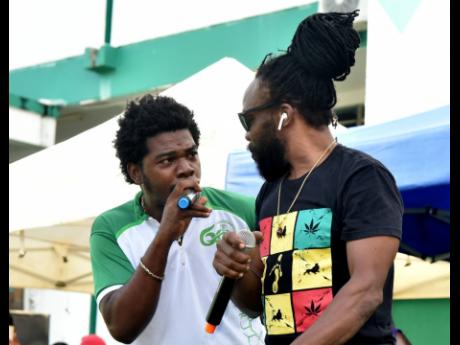 Deejay Romario ‘Di-Ruption’ Weir (left) performing with veteran artiste Bushman. 