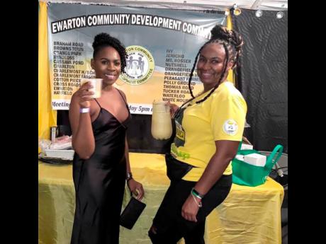 Sharlene Reid (left) samples the ackee punch poured by Sashoy Thomas, president of the                    Ewarton Community Development Committee at Monday’s staging of the Linstead Ackee Festival in St Catherine. 