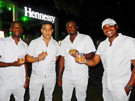 Credit: Contributed Hennessy promoters (from left) Phillip McKenzie, Andre Kong and Lamar Sutherland share a toast with Kamal Powell, regional marketing manager for Magnum.