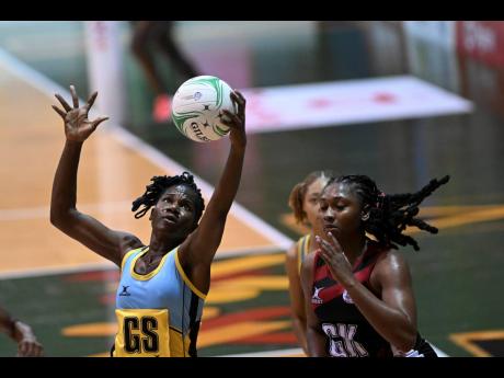Trinidad and Tobago’s (T&T) netball captain Shaquanda Greene-Noel (right) gets ready to challenge Shem Maxwell of St Lucia during their Americas Netball World Cup qualifiers at the National Indoor Sporting Centre on Sunday. T&T won 63-25.