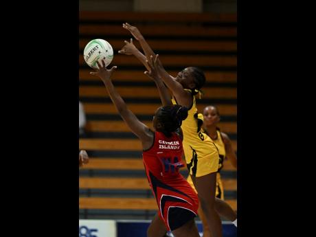 Crystal Plummer battles Cayman Island’s Deidrian Gardner during their Americas World Cup Qualifiers at the National Indoor Sports Centre last Tuesday. Jamaica won 81-27.