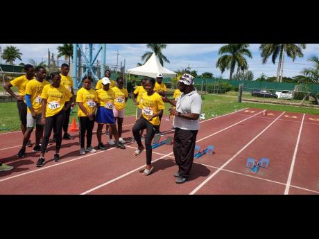 Paul Francis instructs athletes in the sprints technical area at the MVP Grassroots Athletics Programme camp at the Montego Bay Sports Complex, Catherine Hall, on Saturday. 