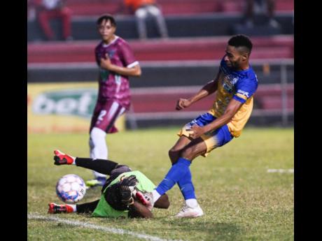 Chapelton Maroons’ goalkeeper Jovell Plunkett makes a point blank save to a shot by Harbour View’s Timar Lewis during their Jamaica Premier league (JPL) match at the Anthony Spaulding Sports Complex on yesterday. Harbour View won 2-0.