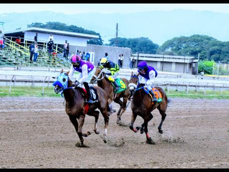 NOMOREDEALS  (left), ridden by Dane Dawkins, wins ahead of SUNSET SILHOUETTE with Abigail Able over 6 and a half at Caymanas Park on Sunday, January 30.