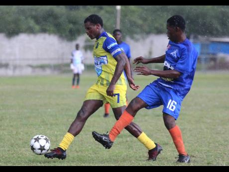 Clarendon College captain Malachi Douglas (left)  marches away from St Mary Technical’s  Kevin Marsh during an ISSA/Digicel daCosta Cup second-leg second-round encounter at Foga Road on October 25. Clarendon won 5-0.