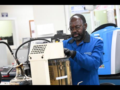 Coke at work inside the lab at Petrojam, where he has worked for 40 years.