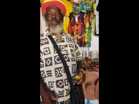 Craft trader Walford ‘Shorty’ Forbes shows off an item which depicts a Rastaman holding a plantain close to his groin area. 