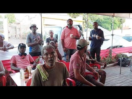 Credit: Roxroy McLean These men braved the early morning temperature to watch the Argentina - Saudi Arabia match at Sonia’s Place on the Terrace on Waltham Park Road in St Andrew.