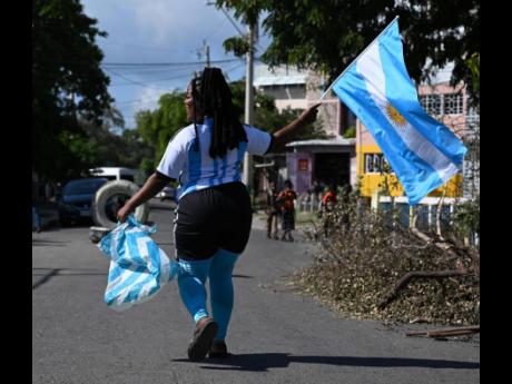 Jody-Ann Walsh marched down Bustamante Highway clad in Argentina team colours on Wednesday. She and other supporters took to the streets to celebrate the team’s win against Poland.