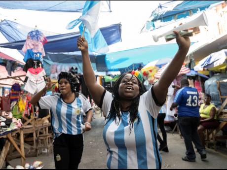 Argentina supporters celebrate their team’s second goal in Wednesday’s must-win game. Argentina defeated Poland 2-0 to progress to the knockout round of the World Cup.