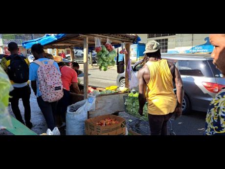 Vendors displaying their wares on the streets of Port Maria, St Mary. They say using the new market does not help them make sales.