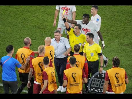 Referee Fernando Rapallini displays a yellow card to a Serbian player from the bench during the World Cup Group G football match against Switzerland, at the Stadium 974 in Doha, Qatar on Friday. Switzerland won 3-2.
