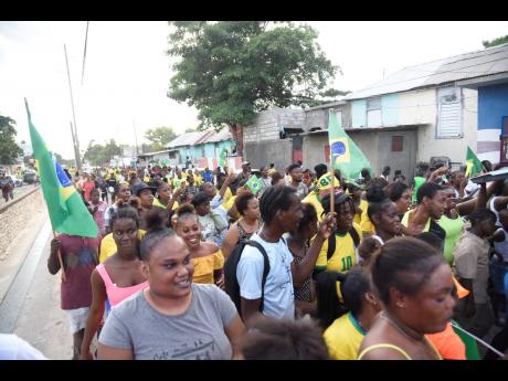 Residents of Trench Town do their Brazil victory parade along Collie Smith Drive yesterday, after the team beat South Korea 4-1 to progress to the quarter-finals.