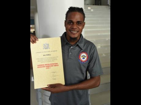 Ira Powell shows off his National Council on Technical and Vocational Education and Training certificate. He and 26 other persons completed the Articulated Truck Driving Level 2 programme.