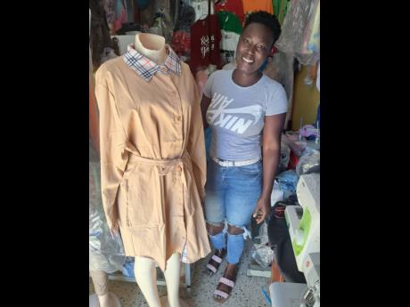 Seamstress Stacien Hinds shows off one of her creations.