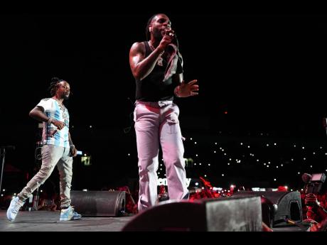 Burna Boy (right) is joined by Popcaan on stage.