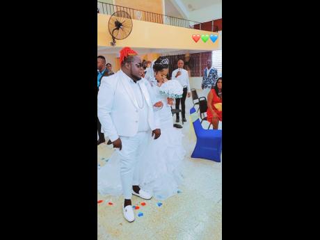 Credit: Contributed Big Pop and his bride Jamila are the centre of attention.