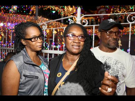 Bridgette McNeil (left) and Adette and Ronald Mitchell were wowed by the decor of the lights along Fairbanks Drive.