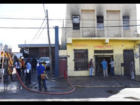 Workers view the damage to the building.