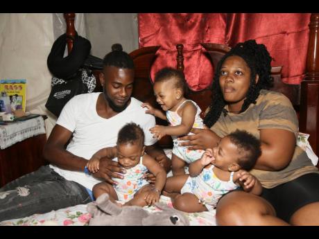 Doting parents Clevone Nicholson and Nyoaka Lindo with their three girls (from left) Kamaya, Katalia and Kahlia. The couple also has a four-year-old son Kaleb.