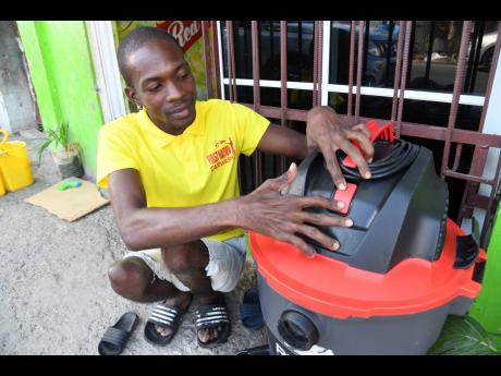 Williams shows his vacuum, which is also a part of his business.