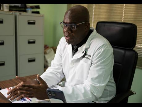 Prominent urologist Dr Elon Thompson speaks in his office.