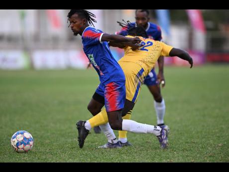 Dunbeholden’s Ricardo Thomas (left) moves away from Molynes United’s Jevaughn Brown during a  Jamaica Premier League match at the Anthony Spaulding Sports Complex on Monday, January 2.
