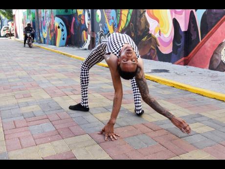 Contortionist Suede ‘Flexible Suede’ Barrant shows off his moves on Water Lane, downtown Kingston.