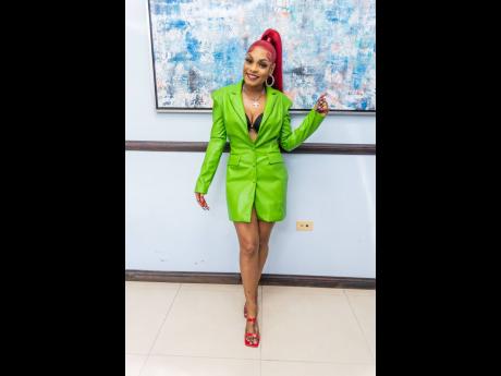 Recording artiste Sasique was clad in a traffic-stopping neon green blazer dress for the signing of the major album deal with Payday Records.