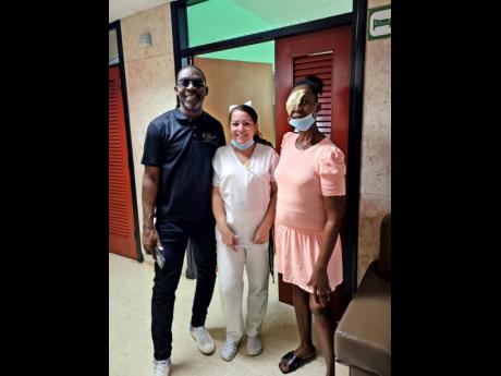 Lisa Grant (right) with Prince Hall of We Believe Ministry and an unnamed nurse after the surgery.  