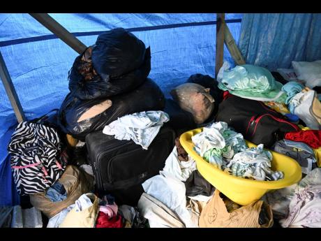 All the family’s belongings are strewn about the shelter in hefty piles like this.