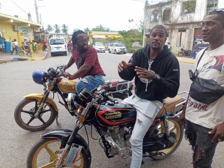Disgruntled bike taxi operators in Grange Hill, Westmoreland, voice their concerns over aspects of the new Road Traffic Act, including the stipulation that the driver of the bike can only carry one pillion.