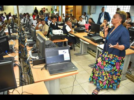 Credit: Contributed Executive Director, Citizen Security Secretariat in the Ministry of National Security, Dianne McIntosh, speaks to high school students at the Kids In Tech forum held recently at the Denham Town High School in Kingston.