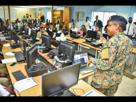 Credit: Contributed Recruitment Officer for the Jamaica Defence Force/Jamaica National Service Corps, Major Merna Riley, speaks to secondary level students during the Kids In Tech forum.