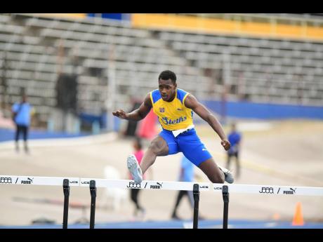 Shamer Blake wins his Class I boys 400 metres heat at Champs last year.