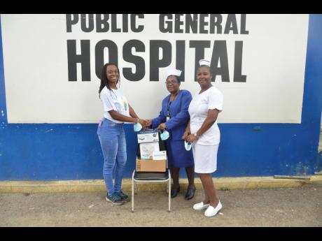 University of Technology Jamaica student, Geri-Ann Miller (left), hands over three nebulisers to Director of Nursing Services at the Savanna-la-Mar Public General Hospital in Westmoreland, Hazeline Forrester (centre), and nurse at the facility Sister Sophia Thomas last Saturday. 
