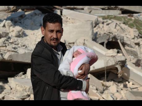 AP Photos
Khalil al-Sawadi holds Afraa, a baby girl who was born under the rubble caused by an earthquake that hit the town of Jinderis, Aleppo province, Syria, earlier this month. Afraa left the hospital and went to her new home with her paternal aunt’s family on Monday. 