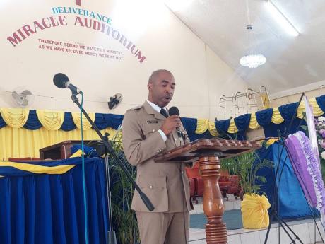 Commander of the St Andrew South Police Division Senior Superintendent Kirk Ricketts reads the eulogy.